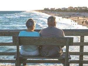 Older couple sitting on pier